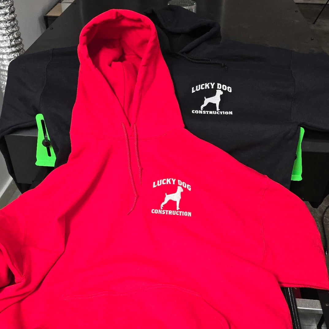 Red hoodie with a logo on a table in an indoor setting