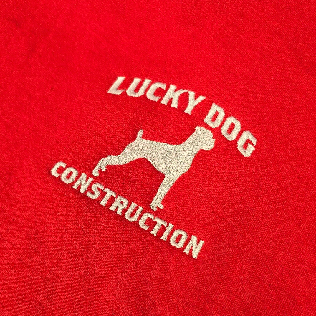 Red hoodie with 'Lucky Dog Construction' logo on a red background