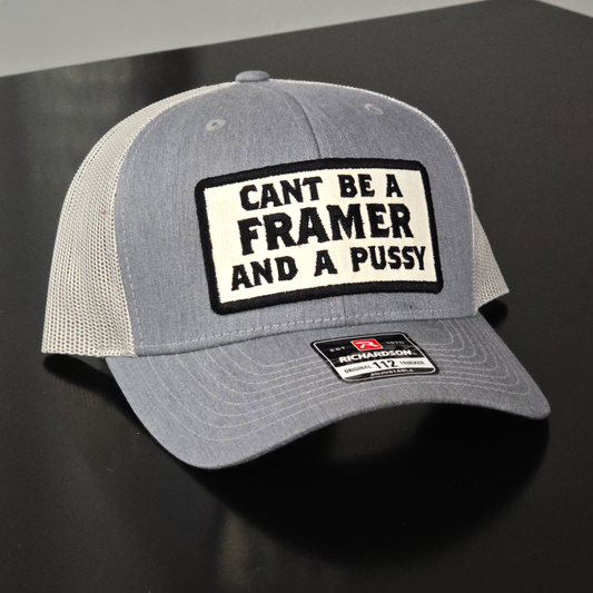 Gray cap with a black and white patch on a dark surface